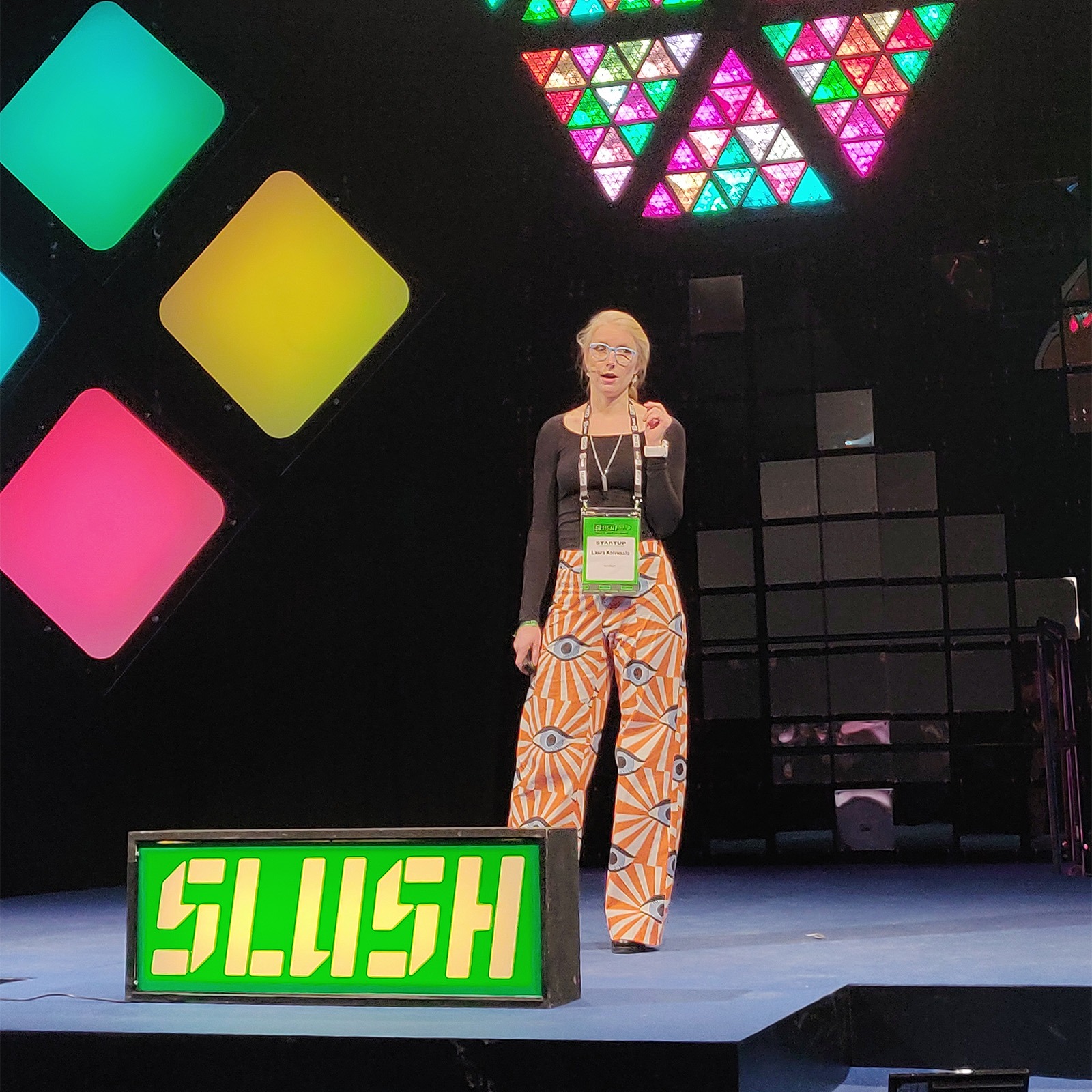 Nov 2021. Laura on stage at Slush wearing her eye pants.